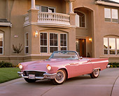 AUT 21 RK1156 09
1957 Ford Thunderbird Convertible Pink 3/4 Front View On Driveway By House