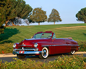 AUT 21 RK1168 02
1950 Mercury Convertible Dark Red 3/4 Front View On Pavement By Grass Hills And Trees