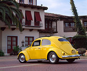 AUT 21 RK1191 05
1956 Volkswagen Bug Rag Top Yellow Low 3/4 Rear View On Pavement By Spanish Building
