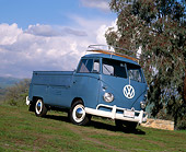 AUT 21 RK1198 03
1959 Volkswagen Type 2 Single-Cab Blue Slanted 3/4 Front View On Grass By Trees Clouds