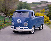 AUT 21 RK1199 02
1959 Volkswagen Type 2  Single-Cab Blue 3/4 Front View On Pavement By Trees And Hills