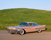 AUT 21 RK1214 02
1958 Cadillac De Ville Sedan Pink 3/4 Side View On Dirt By Grass Hills
