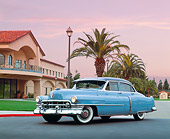 AUT 21 RK1252 03
1950 Cadillac Blue 3/4 Front View On Pavement By Building And Palm Tree Filtered