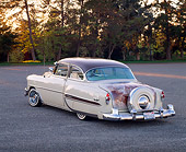 AUT 21 RK1258 03
1953 Chevy Bel Air Lowrider Beige And Brown 3/4 Rear View On Pavement By Trees