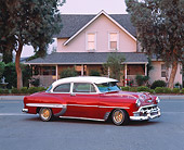 AUT 21 RK1312 04
1953 Chevy Bel Air Lowrider Red 3/4 Side View On Pavement By House And Trees At Dusk