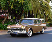 AUT 21 RK1397 03
1959 AMC Rambler Custom Cross Country Wagon Gold And White 3/4 Front View On Pavement By Trees
