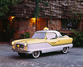 AUT 21 RK1417 03
1956 Nash Metropolitan Taxi Yellow And White 3/4 Side View On Pavement By House