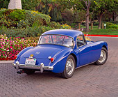AUT 21 RK1467 03
1958 MGA Coupe Blue 3/4 Rear View On Pavement By Flowers