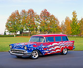 AUT 21 RK1468 02
1957 Chevy 210 Wagon American Flag Graphics 3/4 Side View On Pavement By Grass Fall Trees