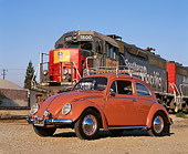 AUT 21 RK1575 04
1958 Volkswagen Beetle Coral Low Front 3/4 View On Dirt By Train