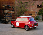 AUT 21 RK1597 04
1959 Mini Cooper Red And White 3/4 Rear View On Gravel By Water Well By Brick Building
