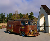 AUT 21 RK1605 02
1954 Volkswagen Panel Bus Rusted 3/4 Front View On Pavement By Flowers And Trees