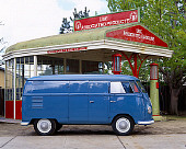 AUT 21 RK1630 02
1954 Volkswagen Panel Van Double Doors Blue Profile On Pavement By Gas Station