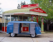 AUT 21 RK1631 01
1954 Volkswagen Panel Van Double Doors Open Blue Profile View On Pavement By Gas Station