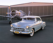 AUT 21 RK1670 02
1952 Chevy Bel Air Hardtop Beige 3/4 Front View On Pavement By Airplane