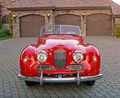 AUT 21 RK1682 01
1951 Jowett Jupiter Roadster Red Head On Shot On Driveway By Garages