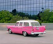 AUT 21 RK1694 03
1958 Studebaker Station Wagon Pink 3/4 Rear View On Pavement By Glass Building And Trees