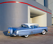 AUT 21 RK1697 01
1958 Chevy Impala Light Blue 3/4 Rear View On Pavement By Building