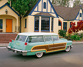 AUT 21 RK1702 06
1956 Cadillac Woody Station Wagon Green 3/4 Rear View On Pavement By House