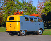 AUT 21 RK1728 02
1955 VW School Bus Prototype Blue And Yellow Rear 3/4 View On Pavement By Trees