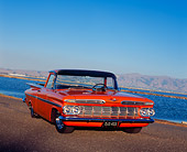 AUT 21 RK1808 02
1959 Chevrolet El Camino Orange Low 3/4 Front View On Pavement By Water Blue Sky