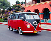 AUT 21 RK1812 01
1956 VW Deluxe Bus Red And Brown 3/4 Front View On Pavement By Building