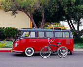 AUT 21 RK1815 09
1956 VW Deluxe Bus Red And Brown Side View By Bicycle