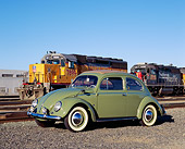 AUT 21 RK1819 02
1952 VW Sunroof Beetle Green 3/4 Side View On Gravel By Train