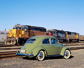 AUT 21 RK1821 03
1952 VW Sunroof Beetle Green 3/4 Rear View On Gravel By Train