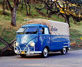 AUT 21 RK1833 01
1954 Volkswagen Single Cab Bus Dove Blue 3/4 Front View On Pavement By Grass Hill And Trees