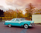 AUT 21 RK1844 01
1955 Ford Crown Victoria Skyliner Two Tone Green 3/4 Side View On Pavement by Trees