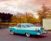 AUT 21 RK1846 03
1955 Ford Crown Victoria Skyliner Two Tone Green 3/4 Rear View On Pavement By Trees