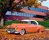 AUT 21 RK1853 02
1952 Chevy Deluxe Salmon And White 3/4 Front View On Fall Leaves By Building
