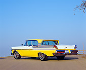 AUT 21 RK1865 02
1957 Mercury Turnpike Cruiser Yellow And White Low 3/4 Rear View On Pavement Blue Sky