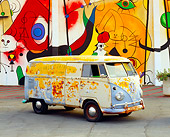 AUT 21 RK1897 01
1959 Volkswagen Bus Type II Front 3/4 View On Pavement By Colorful Wall