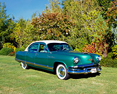 AUT 21 RK1927 01
1953 Kaiser Dragon Green And White 3/4 Front View On Grass By Trees