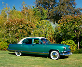 AUT 21 RK1929 02
1953 Kaiser Dragon Green And White 3/4 Side View On Grass By Trees