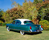 AUT 21 RK1930 01
1953 Kaiser Dragon Green And White 3/4 Rear View On Grass By Trees