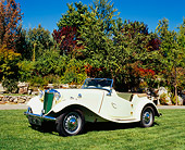 AUT 21 RK1934 02
1952 MG TD Roadster Yellow Side 3/4 View On Grass By Trees