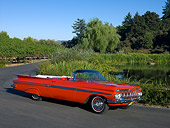 AUT 21 RK1997 01
1959 Chevrolet Impala Convertible Red 3/4 Side View On Pavement By Trees
