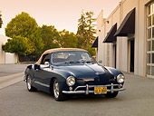AUT 21 RK2032 01
1959 Volkswagen Karmann Ghia 141 Convertible Blue 3/4 Front View On Pavement By Building