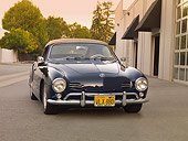 AUT 21 RK2033 01
1959 Volkswagen Karmann Ghia 141 Convertible Blue 3/4 Front View On Pavement By Building