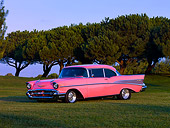 AUT 21 RK2060 01
1957 Chevrolet Bel Air Pink Low 3/4 Side View On Grass By Trees