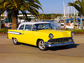 AUT 21 RK2097 01
1956 Ford Mainline Yellow And White 3/4 Front View On Pavement By Harbor