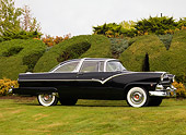AUT 21 RK2118 01
1955 Ford Crown Victoria Black Front 3/4 View On Grass By Shrubs Tree Sky