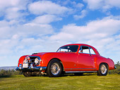 AUT 21 RK2131 01
1953 Nash-Healey Le Mans Coupe Red Front 3/4 View Low Angle On Grass Blue Sky
