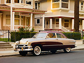 AUT 21 RK2149 01
1951 Ford Crestliner Silver And Maroon 3/4 Front View On Pavement By Houses