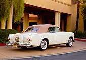 AUT 21 RK2184 01
1953 Packard Caribbean Convertible Ivory 3/4 Rear View By Building