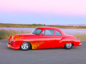 AUT 21 RK2267 01
1950 Oldsmobile 88 Hot Rod Red With Flames Custom Coupe 3/4 Front View On Pavement By Water