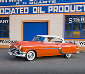 AUT 21 RK2292 01
1954 Pontiac Chieftain Orange 3/4 Front View On Pavement By Building
